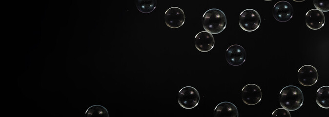 Soap bubble drop or Shampoo bubbles floating like flying in the air black background which...