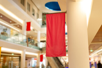 Red vertical flag in the shopping mall. Blank to promote a logo or ad text