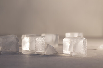 Ice cubes melt on the table.