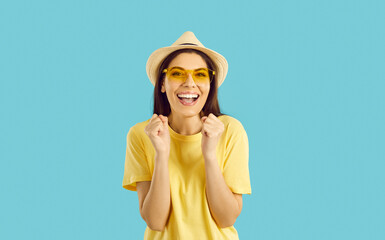 Cheerful beautiful young woman getting excited in anticipation of summer holiday trip. Happy pretty...