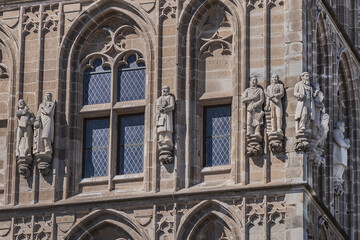 Obraz premium Architectural details of medieval Cologne Town Hall (Rathaus Koln) - XV century Gothic style tower. Cologne, North Rhine Westphalia, Germany.