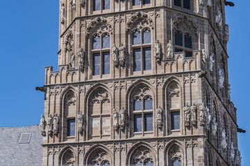 Fototapeta premium Architectural details of medieval Cologne Town Hall (Rathaus Koln) - XV century Gothic style tower. Cologne, North Rhine Westphalia, Germany.