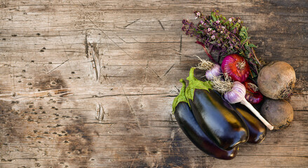 Vegetables of purple color on a wooden countertop.