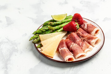 Asparagus. bunch of fresh asparagus, jamon, ham, prosciutto Pickled Green Asparagus. Close up. Keto Paleo diet menu, top view