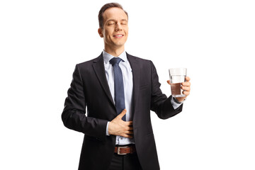 Satisfied businessman with closed eyes holding a glass of water