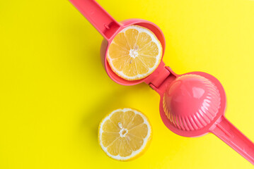 Squeezing a lemon with a pink lemon squeezer