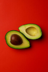 Fresh and tasty avocado on red background