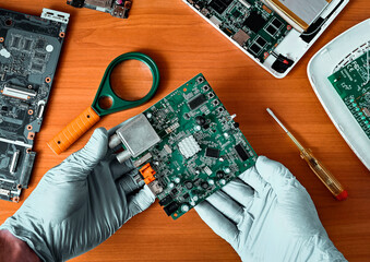 printed circuit board, close-up. PCB repair, troubleshooting. the master in the service center...