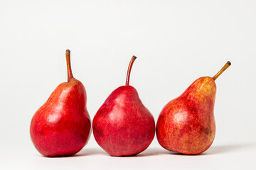 Red pears on a white background. Sweet ripe pear