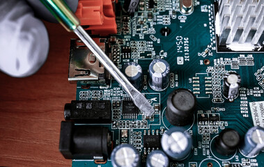 printed circuit board, close-up. PCB repair. master repairs the electronic board with...