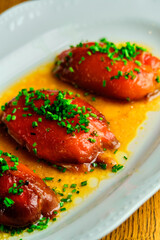 Stuffed pepper with sauce on a white plate