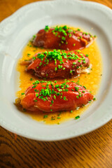 Stuffed pepper with sauce on a white plate
