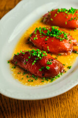 Stuffed pepper with sauce on a white plate