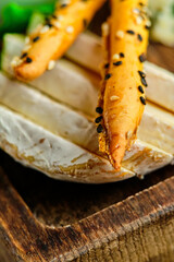 rye bruschetta with honey pumpkin and goat cheese on a dark wood background. tinting. selective focus on mint on the front bruschetta