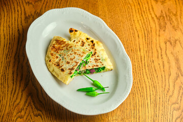 Flatbread stuffed with cheese and herbs. National Georgian dish