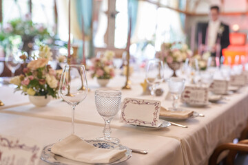Luxurious table setting for a holiday in pastel colors close-up.Empty wine glasses placed in the restaurant. Part of the interior. High quality photo