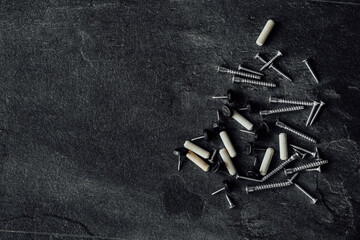 close-up photo of assorted screws for furniture assembly on the wooden table