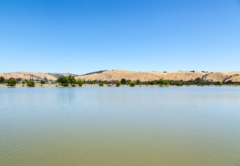 Lake view with beautiful reflections. Hills and forest. Lake Elizabeth in Fremont, California, USA.