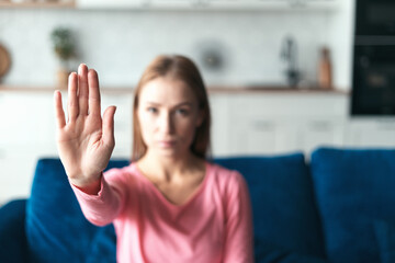 Obraz premium Woman showing stop gesture at camera, protesting against domestic violence