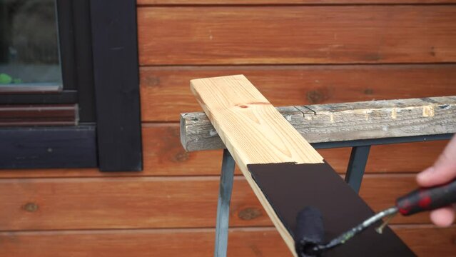 black painting of a wooden trim element for a window in a modern wooden house. High quality 4k footage