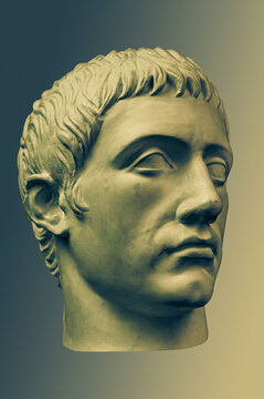 Bronze color gypsum copy of ancient statue of Germanicus Julius Caesar head for artists on brass background. Renaissance epoch. Plaster sculpture of man face. Template for art design