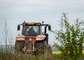 Red Case Puma 340 tractor on a country lane on a country lane