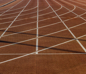Orange running track with markings in the stadium.