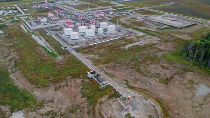 A drone takes off over a torch from an oil producing enterprise. Industrial oil and gas production in Russia or Canada. Fuel crisis in Europe and the United States due to sanctions and war.