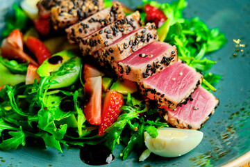 Sliced steak with blood. on a blue plate