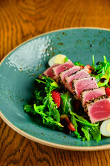 Sliced steak with blood. on a blue plate