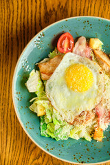 Caesar salad with large fried eggs