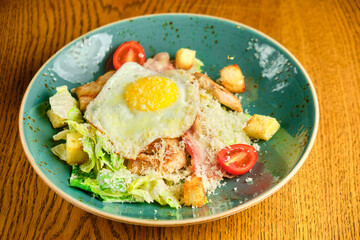 Caesar salad with large fried eggs
