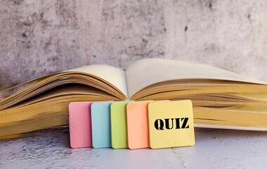 Sticky notes with quiz message and open book