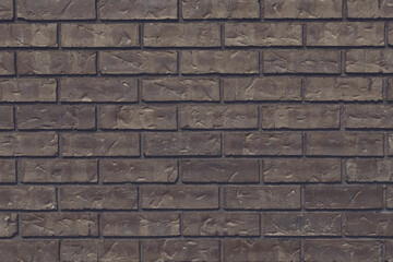 Brown brick painted wall textured background close-up.