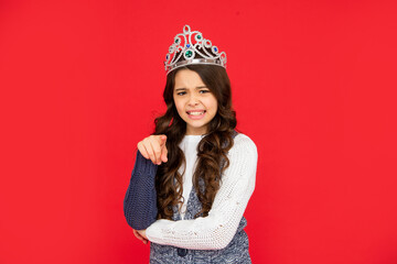 displeased child in queen crown. arrogant princess in tiara. kid pointing finger.