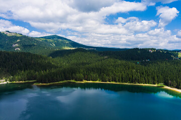 Montenegro. Zabljak. Durmitor National Park. Popular tourist spot. Black lake surrounded by green coniferous forest. Beauty of nature concept background. Drone. Aerial view