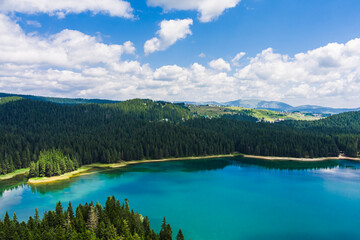 Montenegro. Zabljak. Durmitor National Park. Popular tourist spot. Black lake surrounded by green coniferous forest. Beauty of nature concept background. Drone. Aerial view