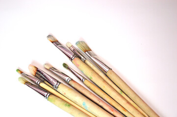 Brushes of different sizes on a white background. Classic flat brushes made of natural bristles for painting on canvas and paper. Free space for text.