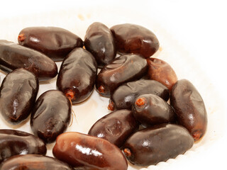 Fresh royal big dates around  white background. close up