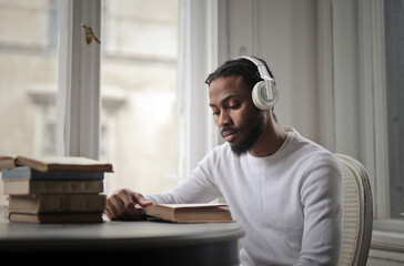 young man studying listening to music