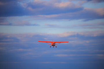 Small private propeller plane flies in the sky
