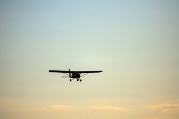 Fototapeta na wymiar Small private propeller plane flies in the sky