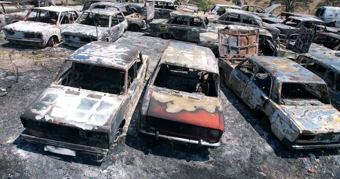 Aerial view of an aftermath of a big disaster of war, bushfire, volcano eruption, ash ground and burnt out cars