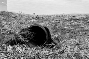 HDPE drainage culvert under a road entrance. Pipe is used to convey stormwater between ditches. - obrazy, fototapety, plakaty