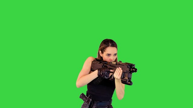 Cyberpunk girl walks with machine gun, taking an aim, making a single shot on a Green Screen, Chroma Key.