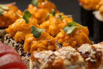 Japanese sushi rolls on a black background macro