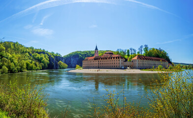 Monastery Weltenburg in Bavaria with a green environment and the Donau river at the foreground