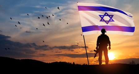Silhouettes of soldiers with Israel flag and flying birds against the sunrise in the desert....