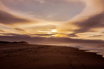 Obraz premium dark clouds at sunset on the sandy beach of Ouddorp near the Northsea