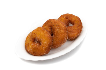 Three Spanish Donuts(Rosquillas) on a white plate, isolated on white background. The donut is a typical Spanish Easter sweet, whose origin dates back to the ancient Roman Empire.